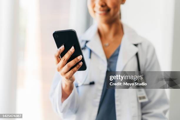 phone, hand and medicine with a doctor doing research online with mobile technology. communication and networking with a woman surgeon working in a hospital for healthcare, science and medical care - doctor using phone stock pictures, royalty-free photos & images