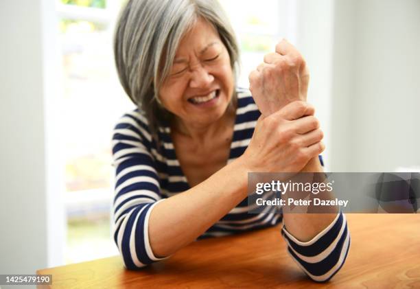 woman with painful wrist - ankylosing spondylitis stock pictures, royalty-free photos & images