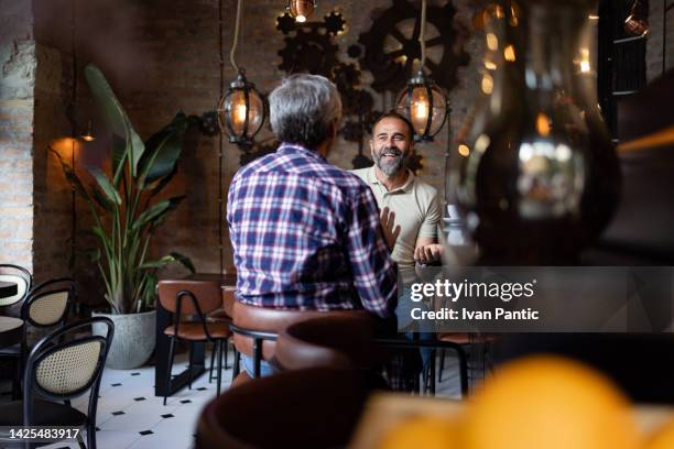 two happy friends meeting for a cup of coffee - cafe culture stock pictures, royalty-free photos & images