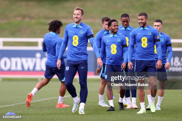 Harry Kane and Kyle Walker of England react during a training session at St George's Park on September 20, 2022 in Burton upon Trent, England....