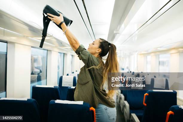 woman in a train - luggage rack stock pictures, royalty-free photos & images