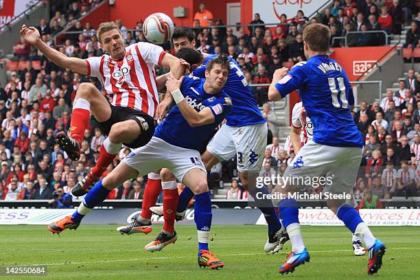 Jos Hooiveld of Southampton heads narrowly wide as Greg Halford of Portsmouth challenges during the npower Championship match between Southampton and...