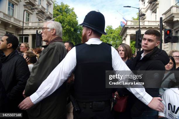 Police officer tries to contain the crowd afterwards at the end of the funeral of Queen Elizabeth II near Hyde Park on September 19, 2022 in London,...