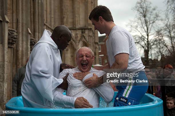 Archbishop of York Dr John Sentamu baptises a local church goer in a water tank during an Easter Saturday ceremony on April 7, 2012 in York, England....