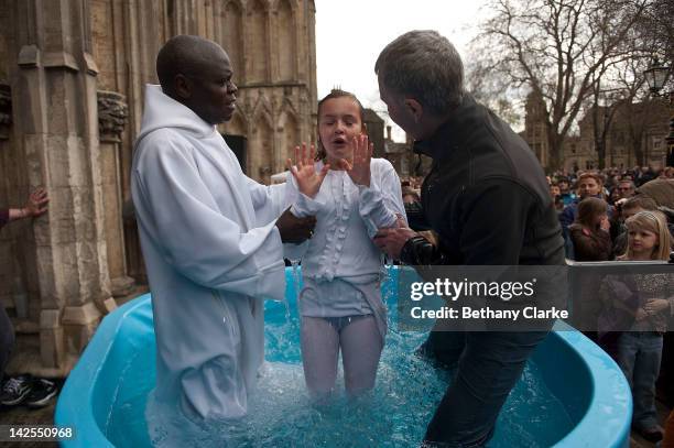 Archbishop of York Dr John Sentamu baptises Santa Mezaka, 12 in a water tank during an Easter Saturday ceremony on April 7, 2012 in York, England....