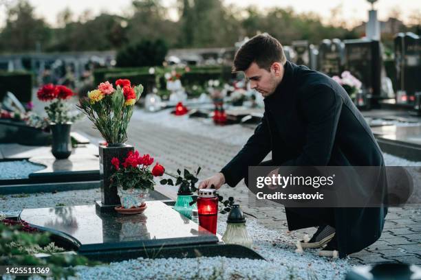 mann am friedhof - grabstein stock-fotos und bilder