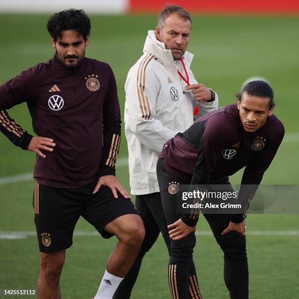 Head coach Hans-Dieter Flick walks past Ilkay Guendogan and Leroy Sane during a Germany training session at DFB-Campus on September 20, 2022 in...