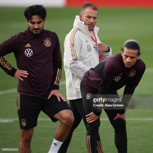 Head coach Hans-Dieter Flick walks past Ilkay Guendogan and Leroy Sane during a Germany training session at DFB-Campus on September 20, 2022 in...