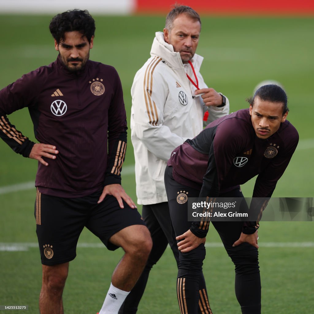 Man Training Session Head coach Hans-Dieter Flick walks past Ilkay Guendogan and Leroy ...