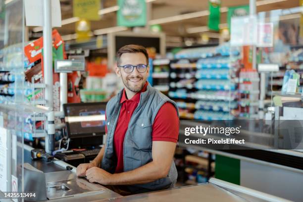 shopkeeper looking at camera - checkout stock pictures, royalty-free photos & images
