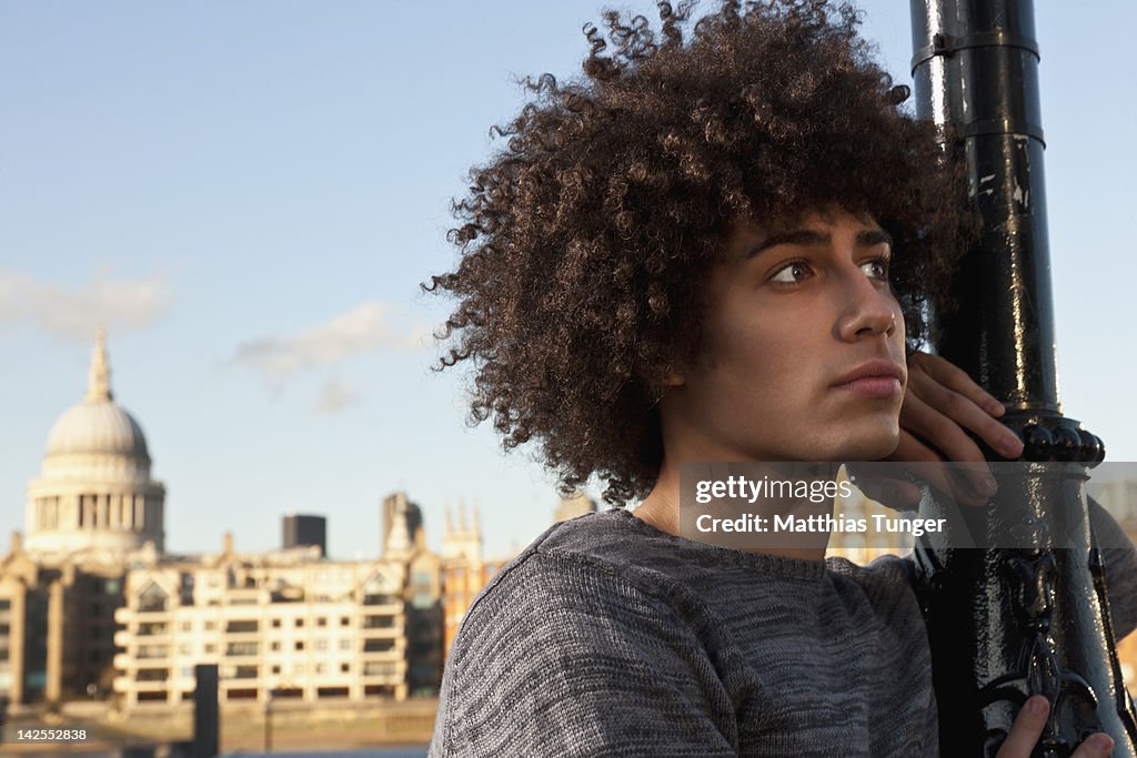 Dancer posing at a lantern in front of a cathedral