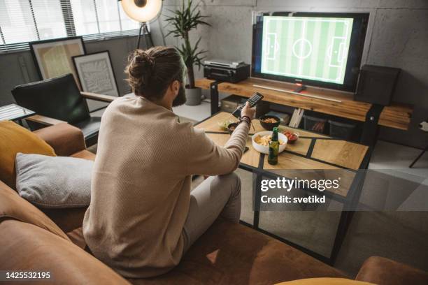 watching soccer game at home - cable tv stock pictures, royalty-free photos & images