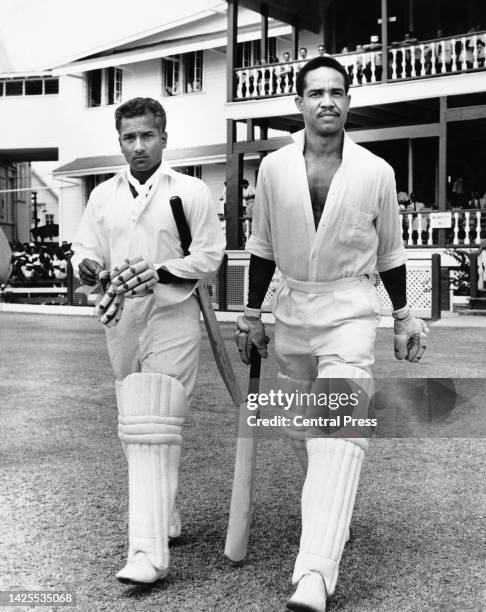 Rohan Kanhai from Guyana and West Indies team captain Garry Sobers from Barbados walk onto the field during the first innings of the 5th Test match...