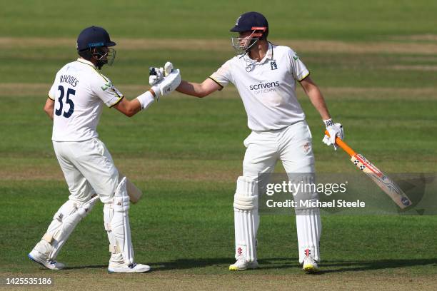 Dom Sibley of Warwickshire is congratulated by Will Rhodes after reaching his half century during day one of the LV=Insurance County Championship...