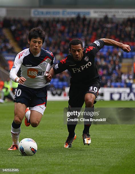 Ryo Miyaichi of Bolton Wanderers in action with Mousa Dembele of Fulham during the Barclays Premier League match between Bolton Wanderers and Fulham...