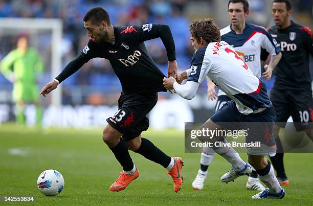 Clint Dempsey of Fulham in action with Marcos Alonso of Bolton Wanderers during the Barclays Premier League match between Bolton Wanderers and Fulham...