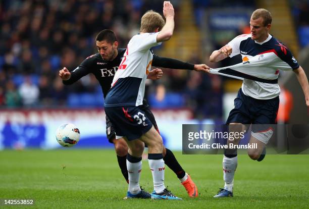 Clint Dempsey of Fulham attempts to move past Tim Ream of Bolton Wanderers during the Barclays Premier League match between Bolton Wanderers and...