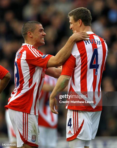 Robert Huth of Stoke City is congratulated by team mate Jonathan Walters after scoring his team's first goal during the Barclays Premier League match...