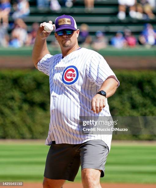 Northwestern baseball head coach Jim Foster throws the ceremonial first pitch of the game between the Chicago Cubs and the Colorado Rockies at...