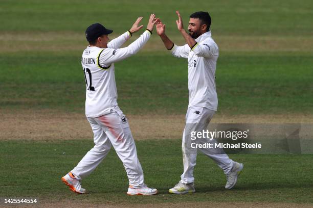Zafar Gohar of Gloucestershire celebrates with Graeme van Buuren after taking the wicket of Jayant Yadav of Warwickshireduring day one of the...