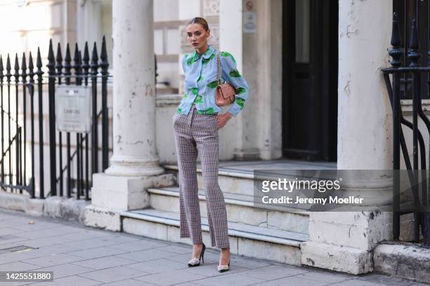 Alina Baikova seen wearing an elegant outfit with a chanel bag, outside paul and joe during London Fashion Week September 2022 on September 17, 2022...