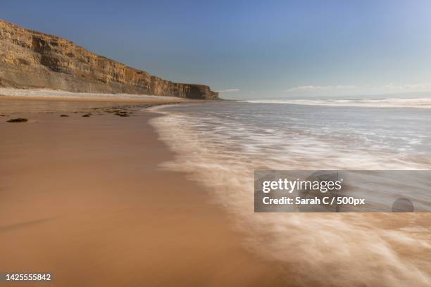 scenic view of beach against sky,southerndown,bridgend,united kingdom,uk - sarah sands stock pictures, royalty-free photos & images