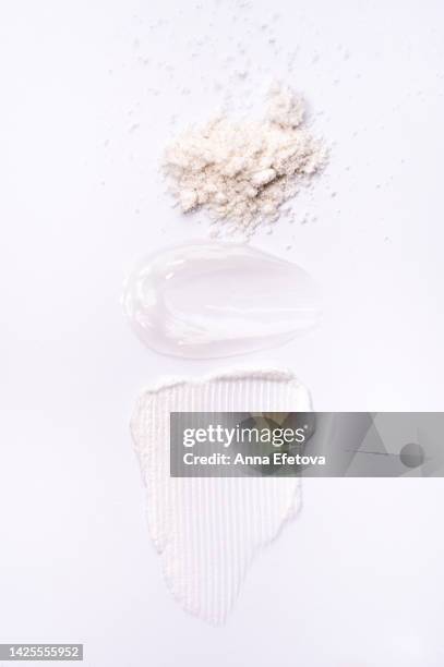 sugar scrub, soothing gel and cleansing foam on white background. beauty products with ceramides, polyglutamic acid and beneficial oils. flat lay style - cipria foto e immagini stock