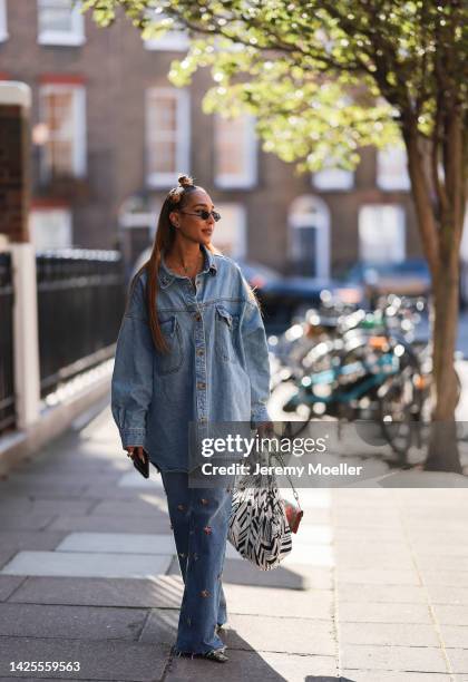 Fashion week guest seen wearing a denim look, outside paul and joe during London Fashion Week September 2022 on September 17, 2022 in London, England.