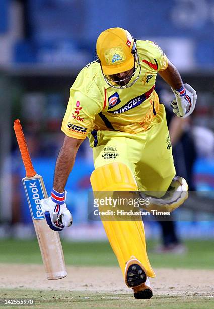 Dhoni captain of Chennai Super Kings drops his bat as he runs into the crease while taking a run during the IPL Indian Premier league 2012 cricket...