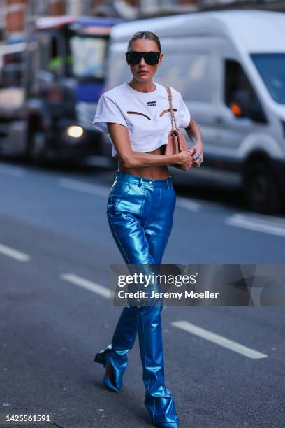 Alina Baikova seen wearing a chanel bag and blue shiny leather pants, outside poster girl during London Fashion Week September 2022 on September 16,...