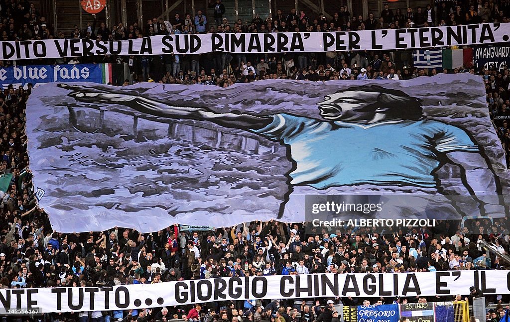Lazio's supporters hold a banner paying