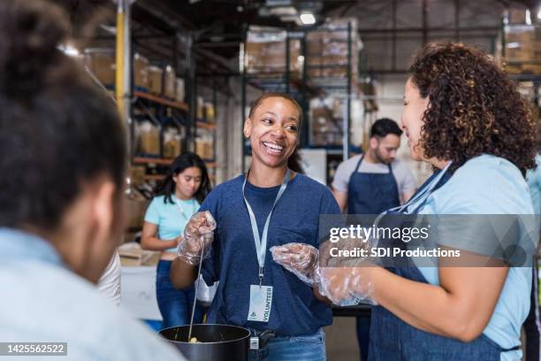 multiracial group work at the food drive - feeding hungry stock pictures, royalty-free photos & images