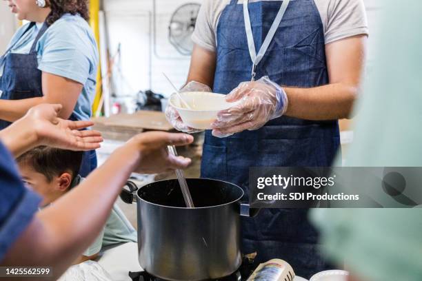 unrecognizeable people serving food - factory cafeteria stock pictures, royalty-free photos & images