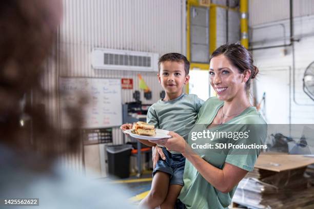 young mother and son receive food - food insecurity stock pictures, royalty-free photos & images