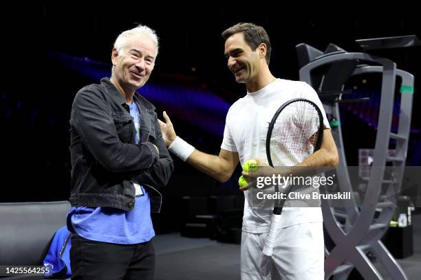 Roger Federer talks to John McEnroe during a practice session ahead of the Laver Cup at The O2 Arena on September 20, 2022 in London, England.