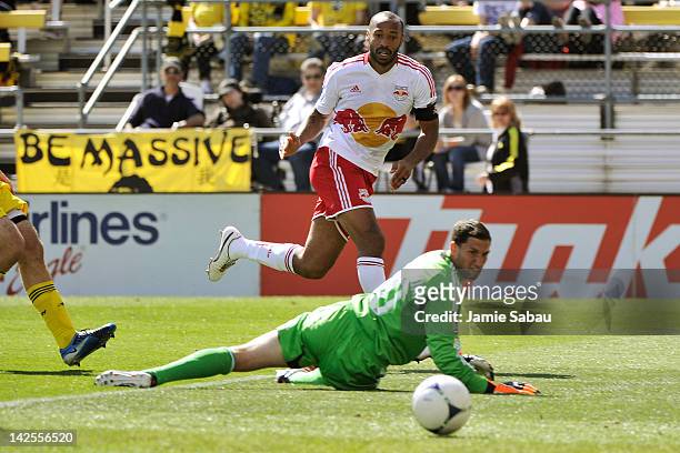 Thierry Henry of the New York Red Bulls watches as his touch on the ball goes past goalkeeper Andy Gruenebaum of the Columbus Crew for the third goal...