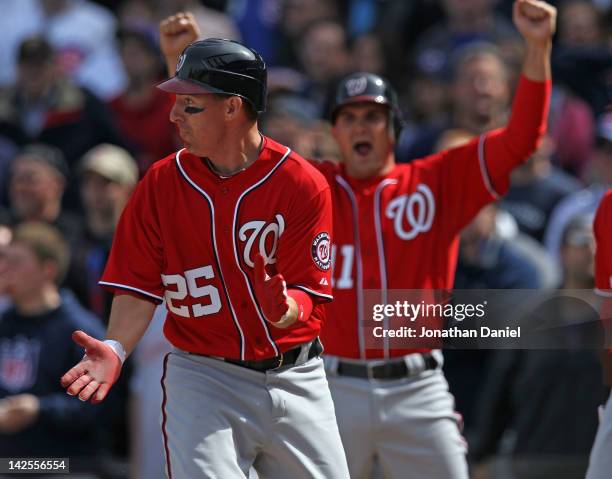 Adam LaRoche and Ryan Zimmerman of the Washington Nationals celebrate after LaRoche scores in the 8th inning against the Chicago Cubs at Wrigley...