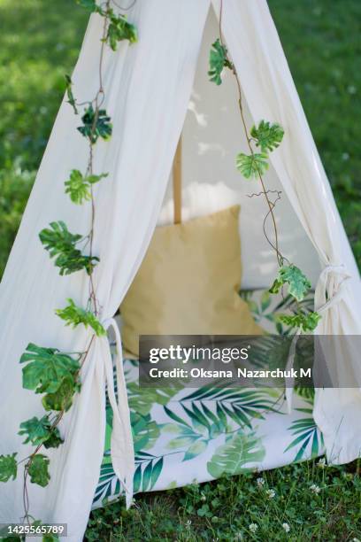 childs teepee house with leaves garland - wigwam garden stock pictures, royalty-free photos & images