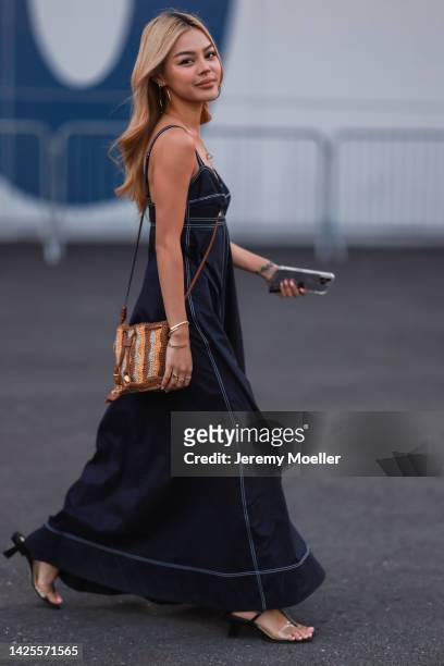 Fashion week guest seen wearing a blue Tory Burch dress, outside Tory Burch Show during New York Fashion Week on September 13, 2022 in New York City.