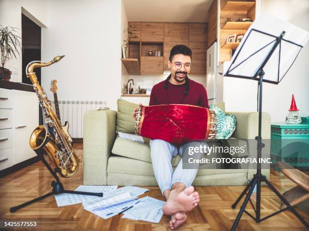 young male musician practising tabla at home - tabla stock pictures, royalty-free photos & images