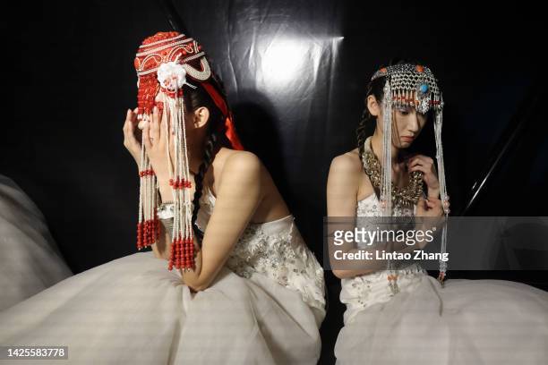 Models prepare backstage before the FENG SANSAN 2023 S/S collection show during the day six of Beijing Fashion Week at Wangfujing street on September...