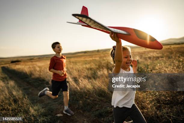 brother and sister playing - model aeroplane stock pictures, royalty-free photos & images