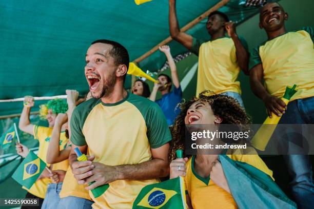 happy brazilian fans at the stadium - venues and sites stock pictures, royalty-free photos & images