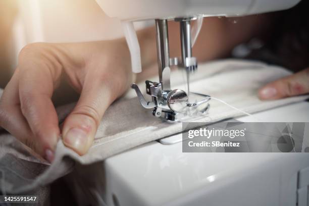 close-up of person working on table - sewing machine imagens e fotografias de stock