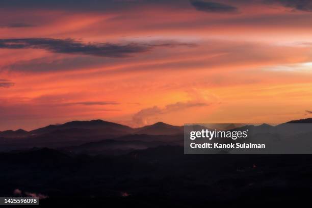 sunset on a foggy mountain range - desert dusk stock pictures, royalty-free photos & images