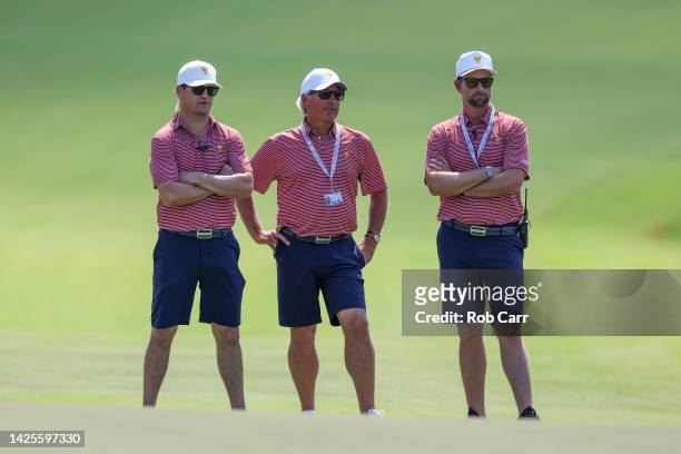Assistant Captain Zach Johnson, Assistant Captain Fred Couples and Assistant Captain Webb Simpson of the United States Team stand on the 15th green...