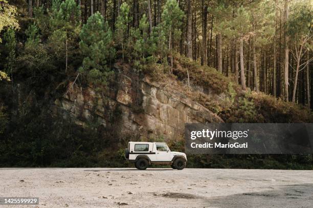 old 4x4 car in a mountain area - car side stock pictures, royalty-free photos & images