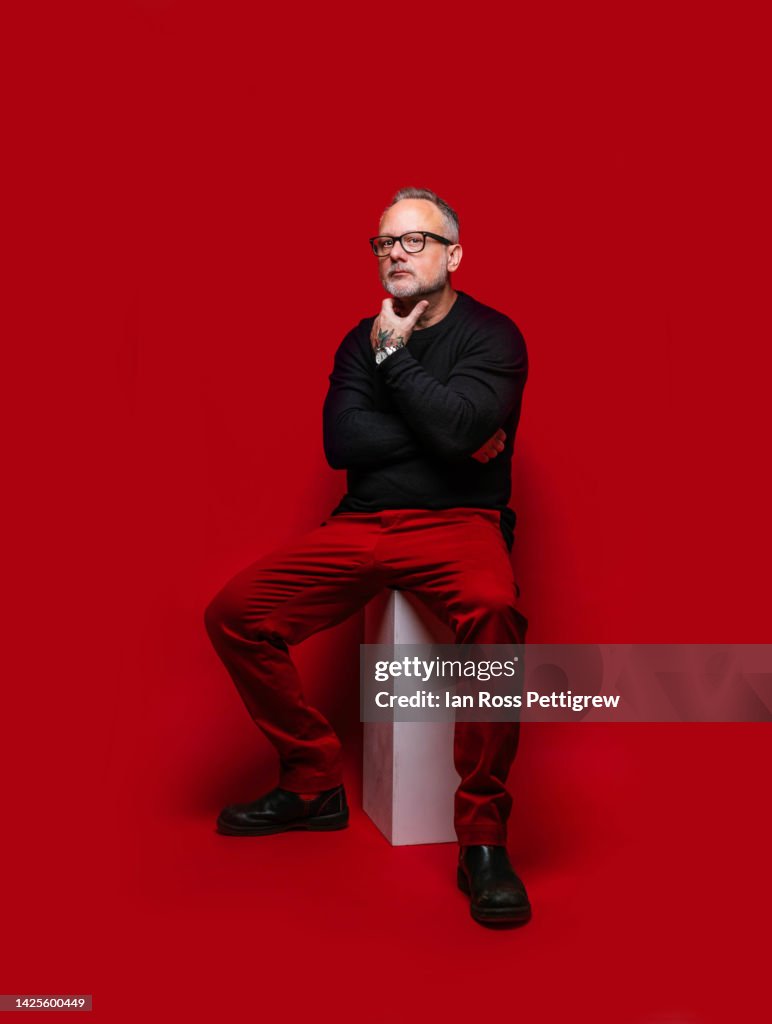 Middle-aged man on red background