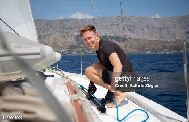 man on a sailboat, looking at camera - croatia cruise stock pictures, royalty-free photos & images