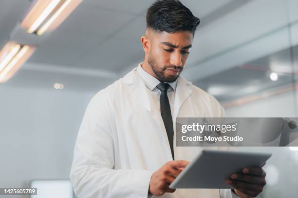 telehealth doctor man, connect digital tablet and virtual healthcare analysis, medical service and focus planning online. indian wellness worker, medicine research and clinic report internet results - handsome doctors stockfoto's en -beelden